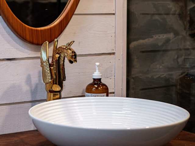 Gold swan faucet in the bathroom