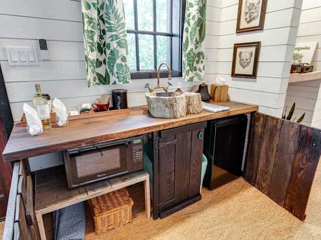 Our kitchenette has a microwave, mini fridge, picnic basket, coffee, tea, water, wine, and more!