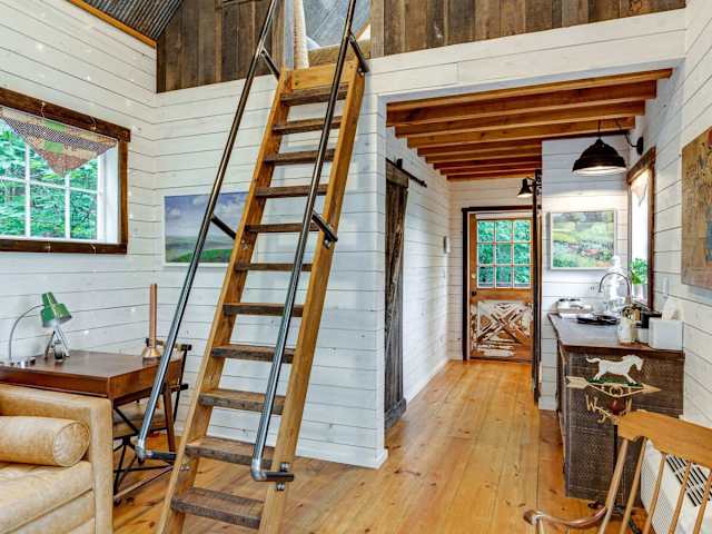 A view from the living space to the loft and front entrance