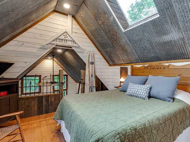 Up in the loft, enjoy a queen bed, sitting space, and 1900's phonograph
