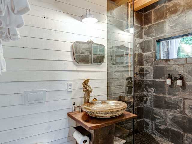 Our bathroom features a custom garden statue faucet with birdbath sink, a floating 