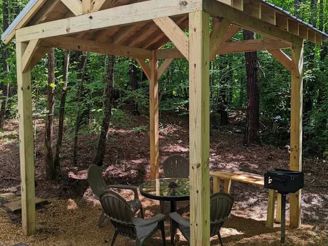 Private dining pavilion located next to each wagon with charcoal camping style grill