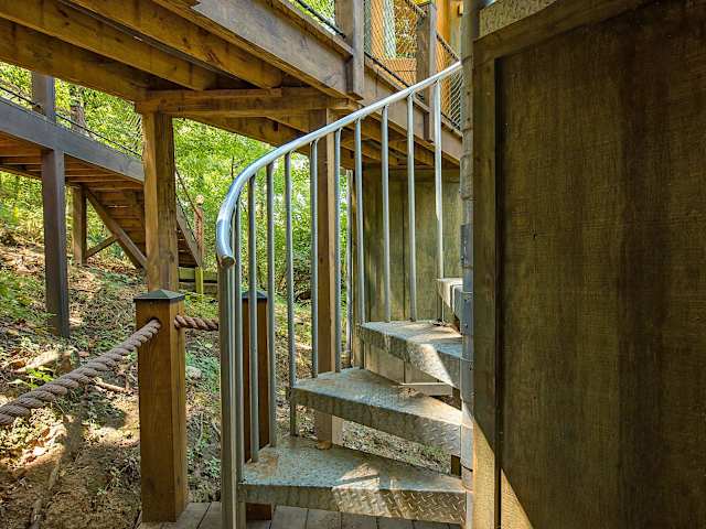 Bedroom and living room are upstairs, while the kitchen, bathroom, and sauna are down a short flight of stairs.