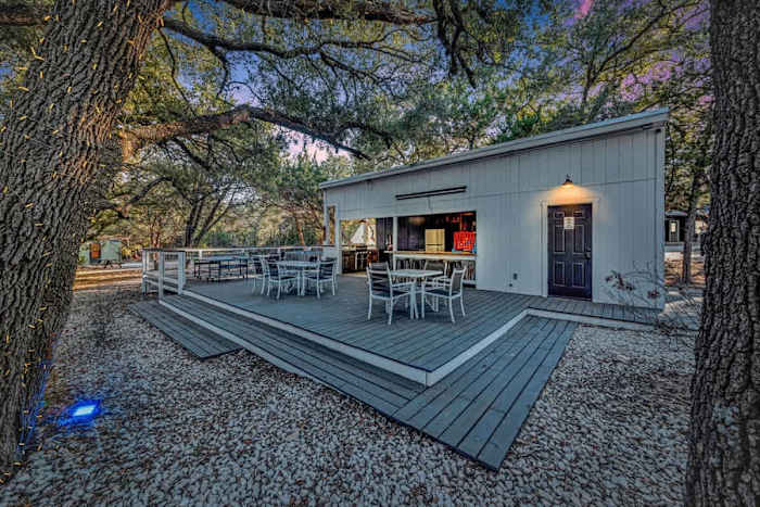 Sleeps 20+| Hot Tubs | Cowboy Pools | Projector TV — Clubhouse Patio featuring ample seating, propane grill, full fridge, kitchen sink, & 2 full baths!