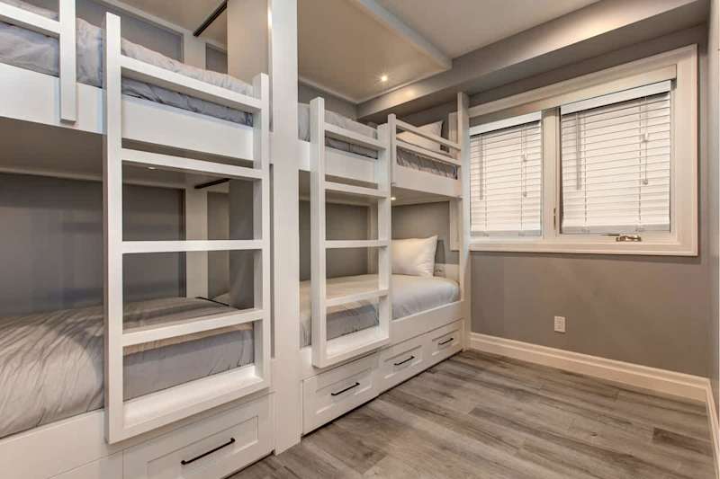 Bedroom 5 | Lower Level, 2 Sets of Twin over Twin Bunks, TV, Closet, Full Ensuite Bathroom with Shower | Abode at First Chair