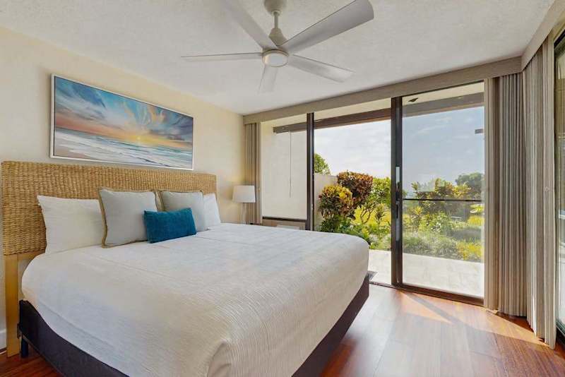 Relax in style, this airy, coastal-themed bedroom offers seamless indoor-outdoor flow