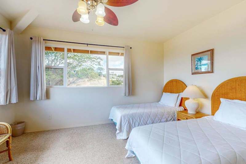 Second bedroom offers bright tropical styling and comfortable sleeping space