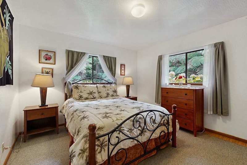Primary Bedroom with Wrought-Iron Bed, Nightstands & Dual Windows
