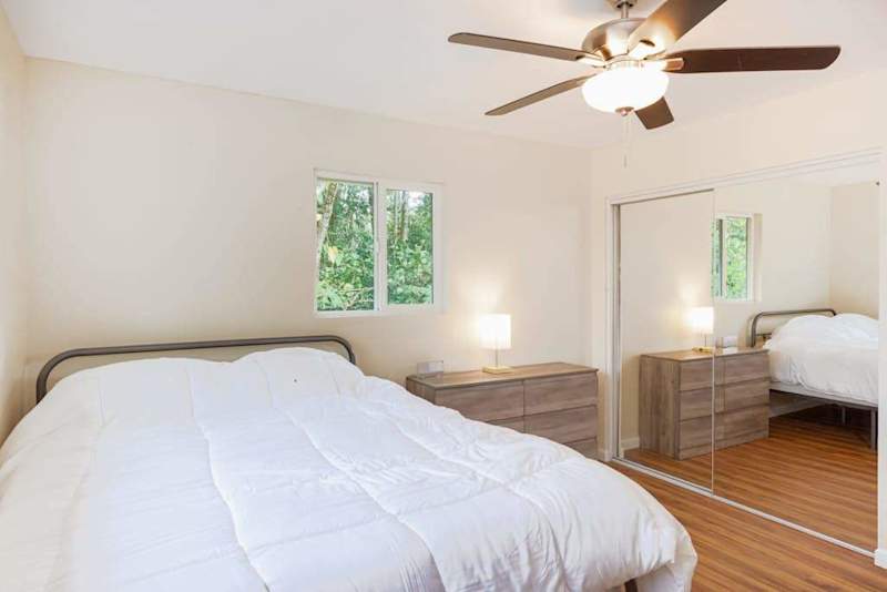 Guest room with double bed and a ceiling fan for added comfort at night.