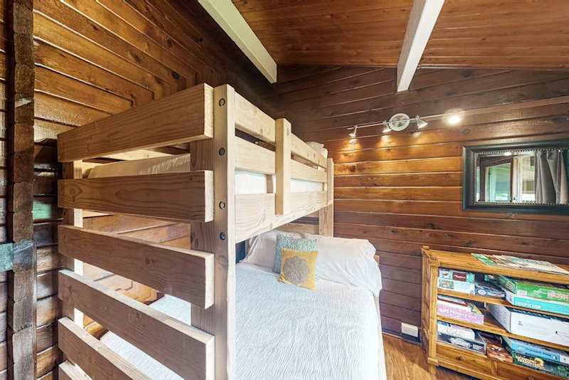 Guest room with bunk beds with a double and twin bed.