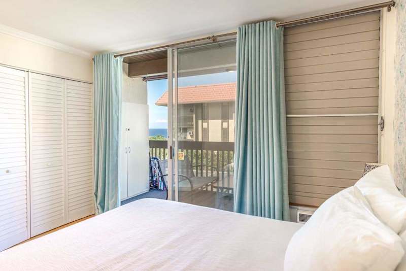 Comfortable Bedroom with Sliding Glass Doors to Private Balcony