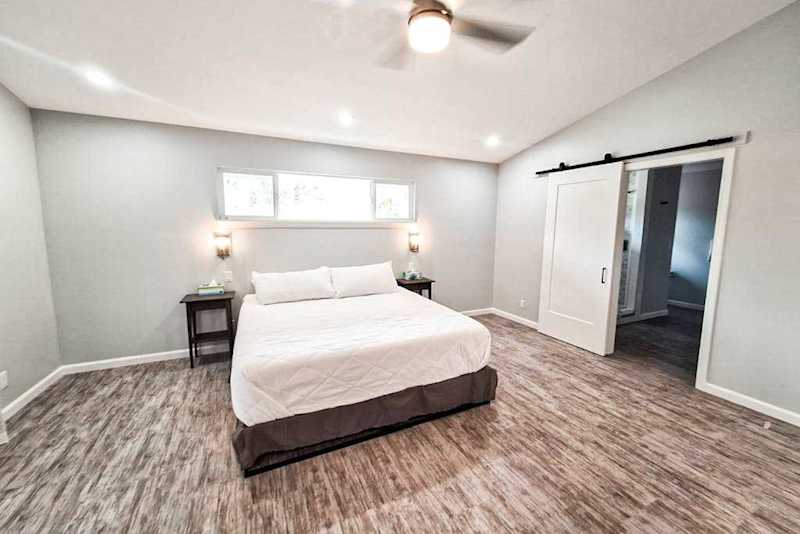 Large master bedroom with king bed and sliders to access the outside.