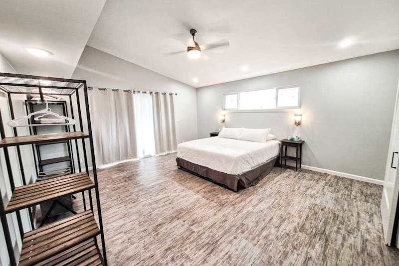 Large master bedroom with king bed and sliders to access the outside.
