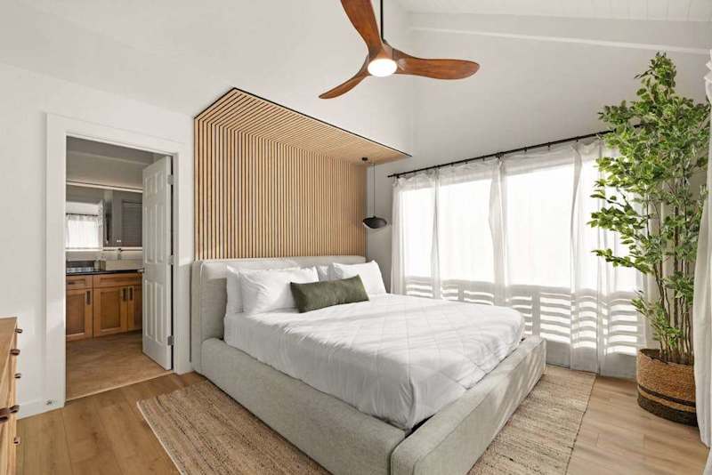 Cozy bedroom with large windows and abundant natural light
