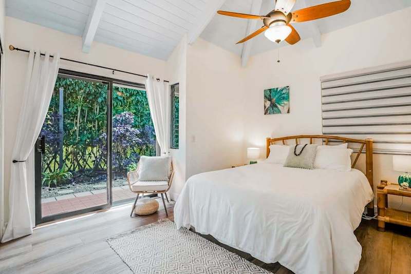 Guest bedroom with queen bed and lanai access.