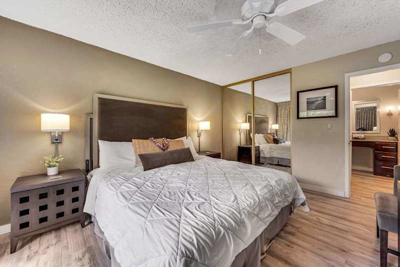 View of Primary Bedroom Showing Mirrored Closet Doors and En-Suite Bathroom Entry
