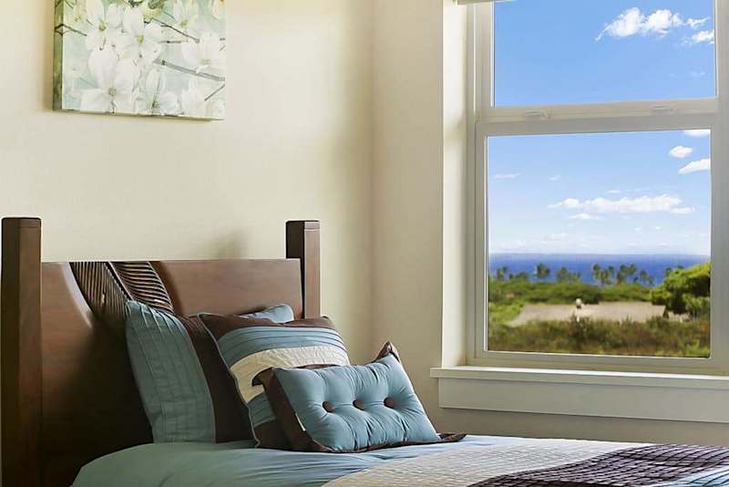 Guest room with two twin beds and flat screen TV.