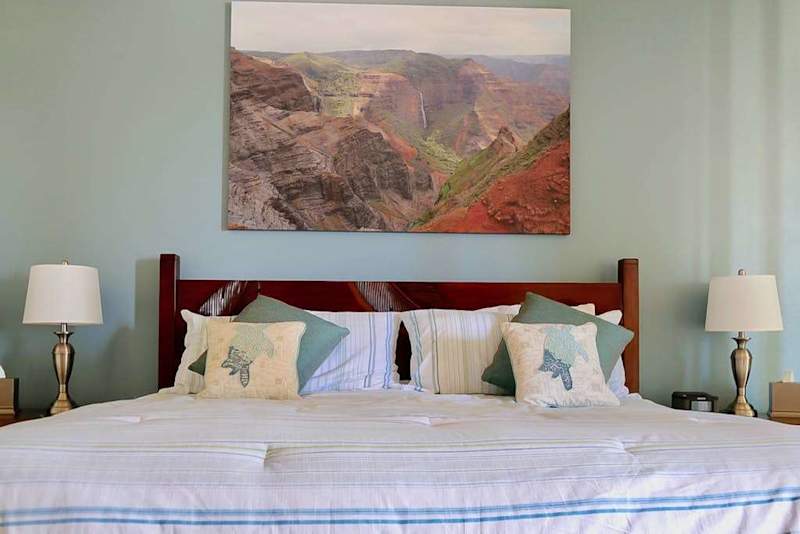 Guest room with king bed with flat screen tv.