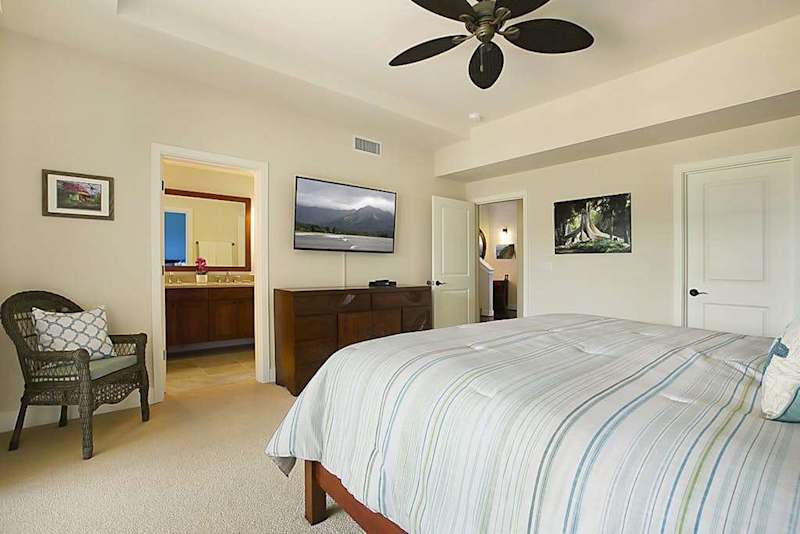 Calming main bedroom with a king bed, private lanai, flat screen tv and en suite bathroom.