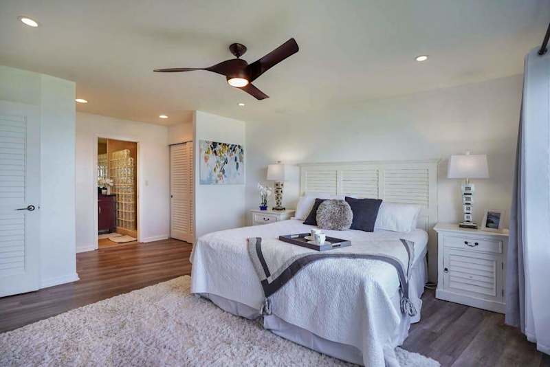 Comfortable bedroom with a ceiling fan and soft natural light