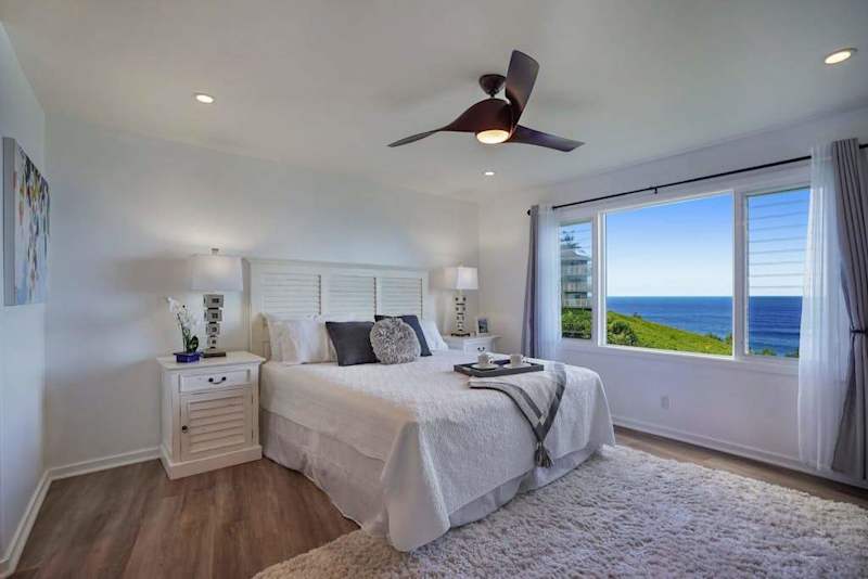 Cozy bedroom with an ocean view from the window