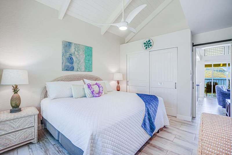 Comfortable king bed in a spacious island-inspired bedroom.