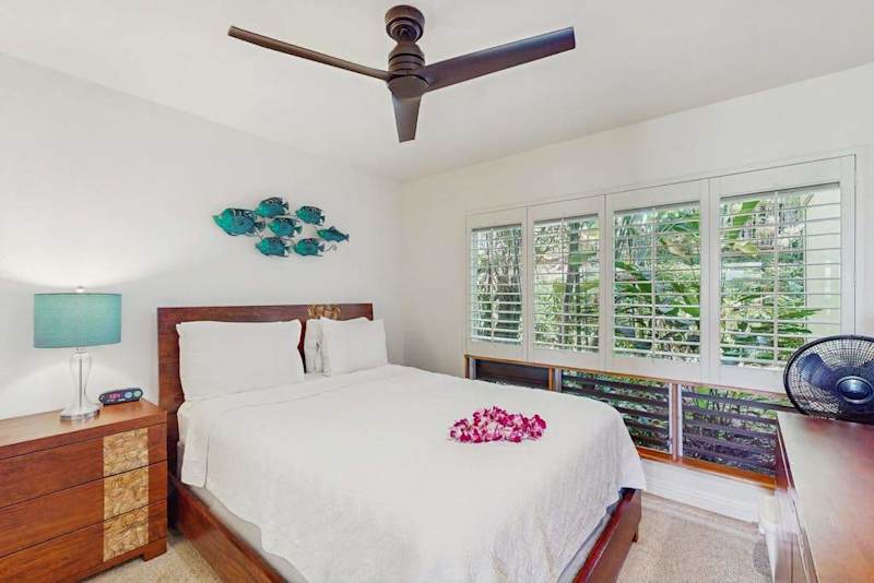 Comfortable sleeping area showcases coordinated decor and soothing natural light