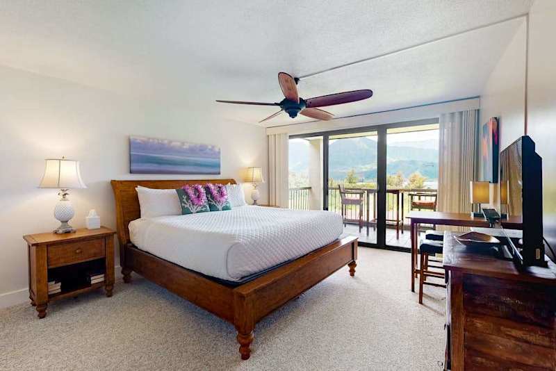 Rest peacefully in this bright bedroom with refreshing outdoor views