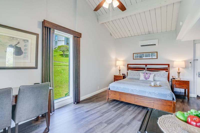 Relax in this airy bedroom with easy outdoor access nearby