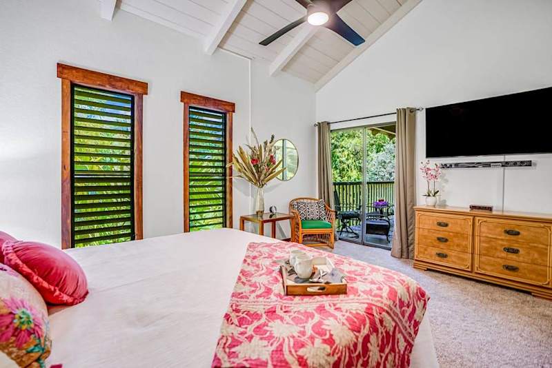 Master bedroom with king bed, private lanai access, flat screen tv and ensuite bathroom.