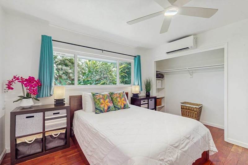 Compact bedroom designed with a breezy, tropical aesthetic
