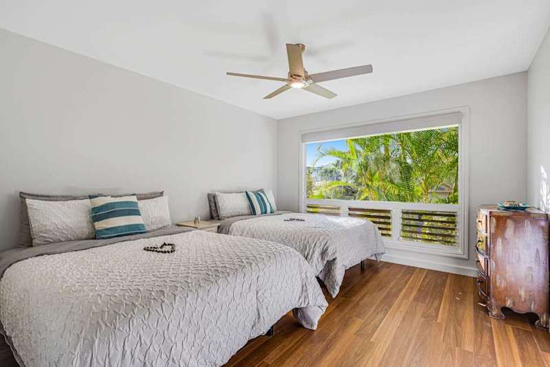 Spacious suite with double beds, ceiling fan and garden view