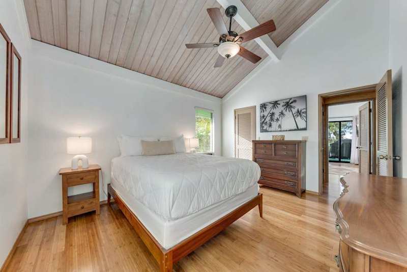 Soft bedside lamp complements crisp linens warm floors and garden