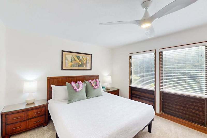 Spacious king bedroom with large windows and natural light