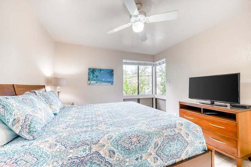 Airy bedroom with comfortable bedding and plenty of natural light
