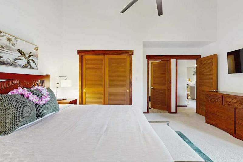 Bright Primary Bedroom With Vaulted Ceilings