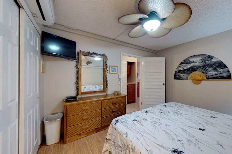 Cozy bedroom with dresser and TV
