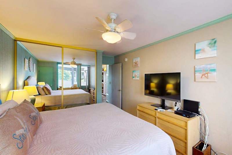 Bedroom With Smart TV And Balcony Access
