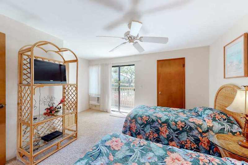 First floor bedroom with rattan accents and lanai access