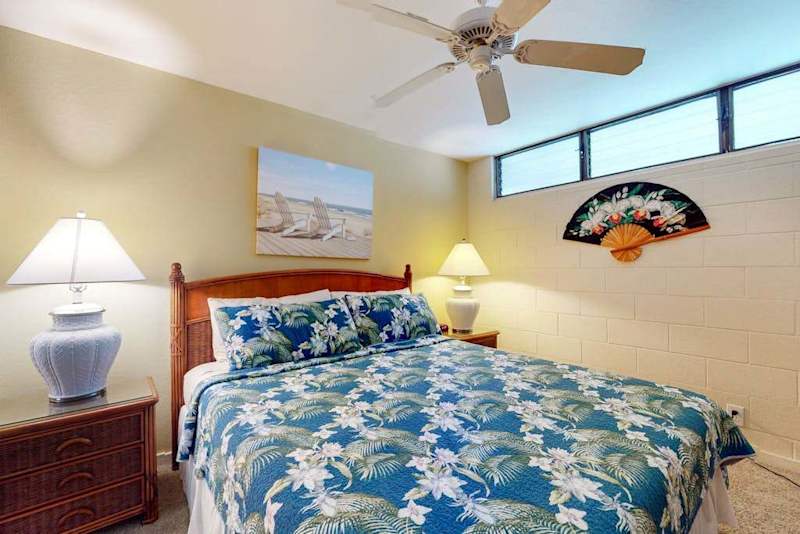 Serene Bedroom Suite with Tropical Bedding & Ceiling Fan