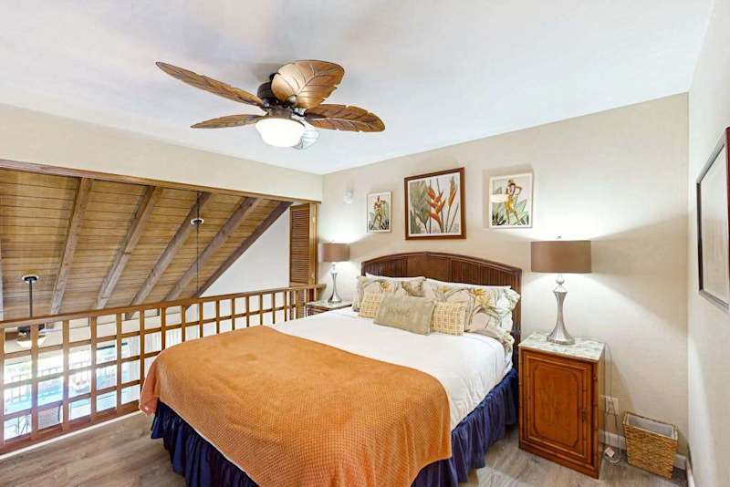 Secondary Bedroom Loft Level featuring King Bed and Ceiling Fan
