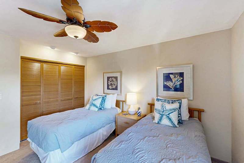 Coastal Bedroom featuring Two Twin Beds and Built-in Closet
