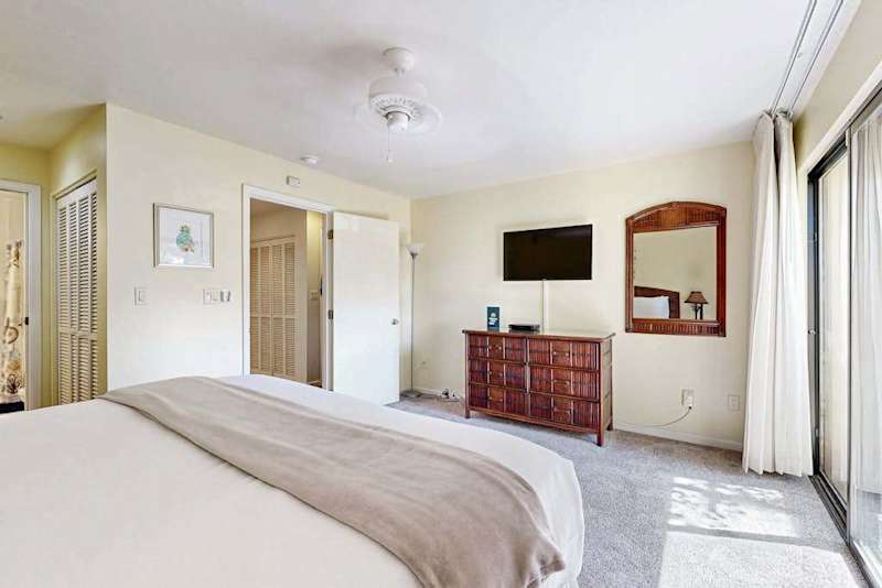 First Bedroom welcomes peaceful sleep beside useful bedside storage nightly