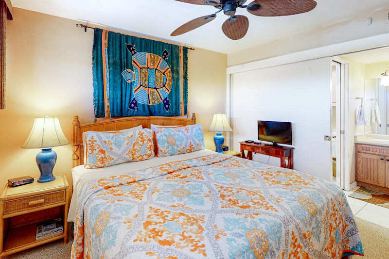 Peaceful Bedroom With Island Charm and a King sized bed