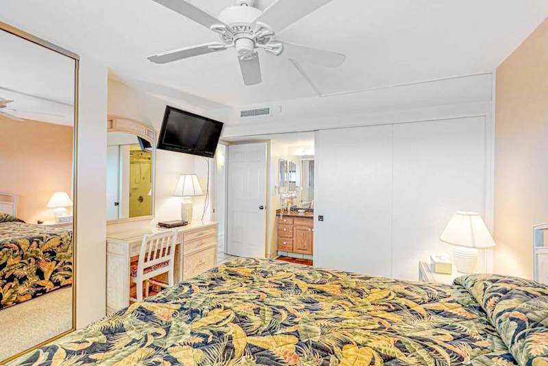 Bedroom with king bed and flat screen tv.