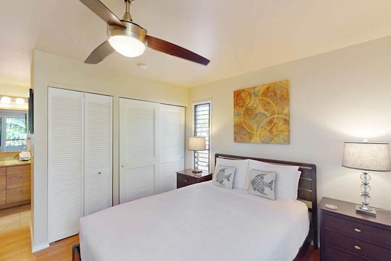 Cozy Bedroom with Queen Bed, Ceiling Fan, Bedside Tables, and En-Suite Access