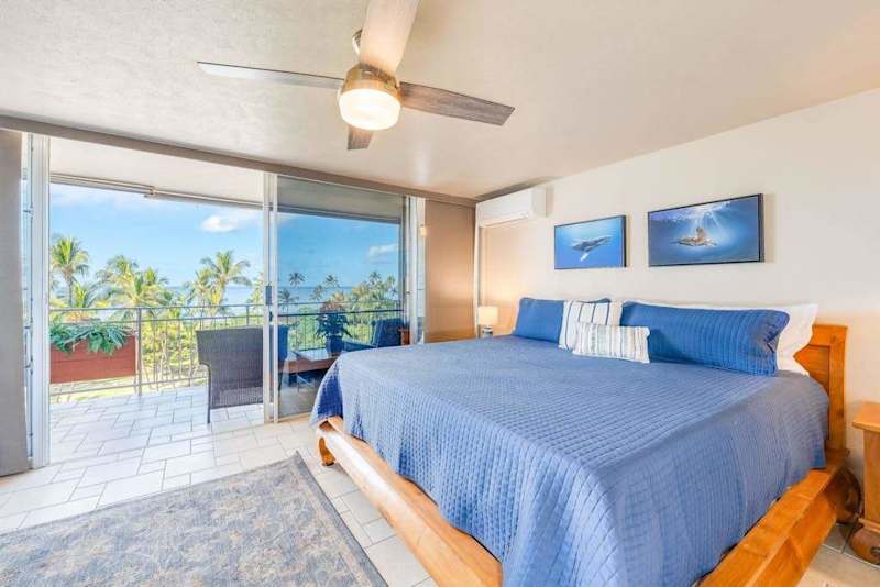 Master bedroom with king bed and balcony access