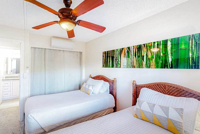 Guest room with two twin beds and a ceiling fan for your comfortable all night long.