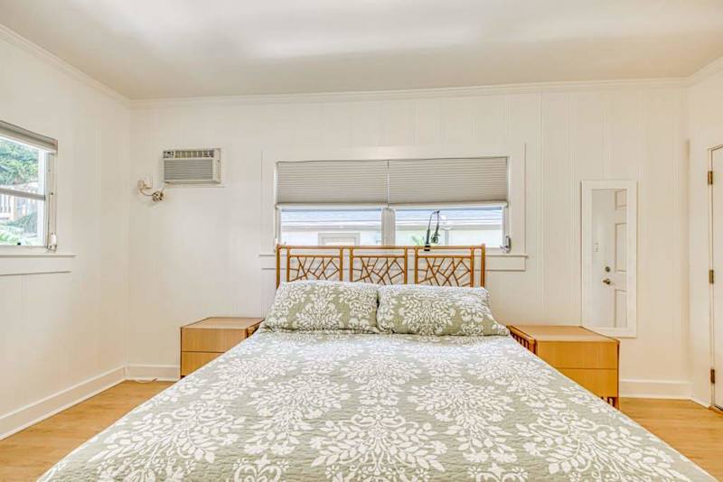 King bedroom with a spacious layout and softly filtered daylight