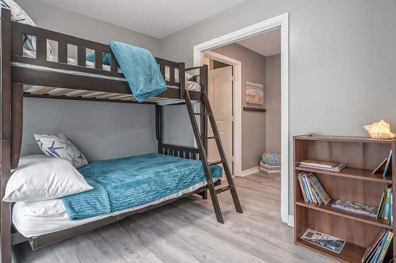 Rest easy in this quiet sleeping retreat featuring Queen over Queen bunk